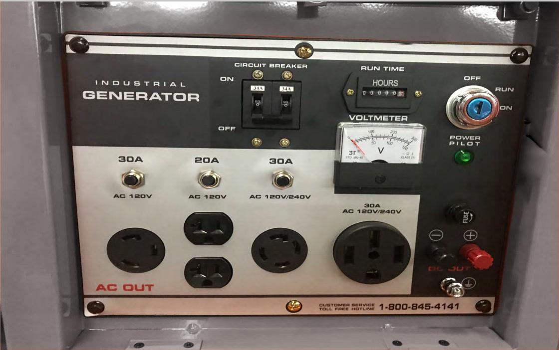 Control panel of an industrial generator with various switches and indicators.